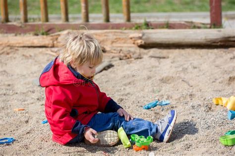 Cute Toddler Child Blond Boy Playing On The Playground Stock Photo