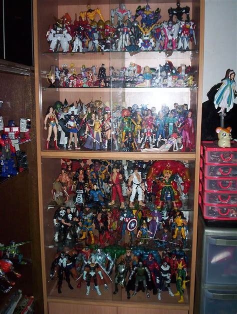 A Wooden Shelf Filled With Lots Of Action Figures