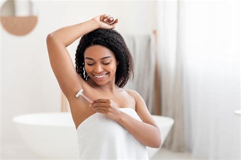 Premium Photo Portrait Of Smiling Black Female Shaving Underarm With