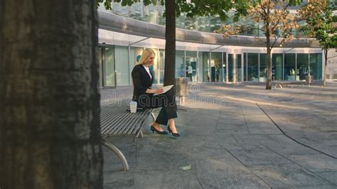 Successful Business Woman Taking Notes Outdoors Side View Of Elegant