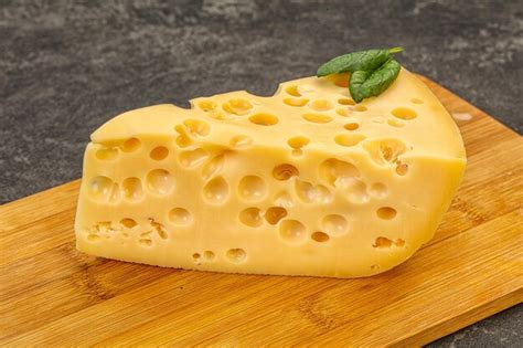 Premium Photo Maasdam Cheese Yellow Triangle With Holes