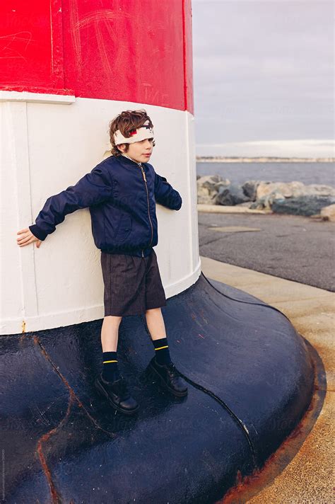 Boy Wearing A Handmade Hachimaki Leaning Against A Lighthouse Looking