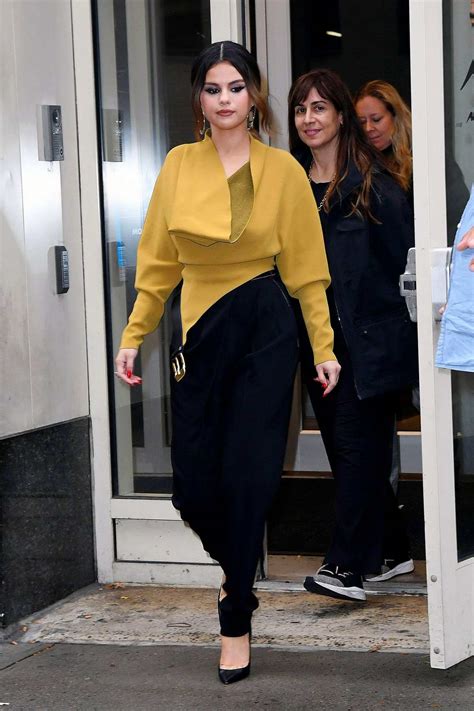 Selena Gomez Rocks A Mustard Yellow Top And Black Trousers As She