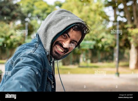 Follow Me Concept A Smiling Young Man Walking Outdoors Holding His