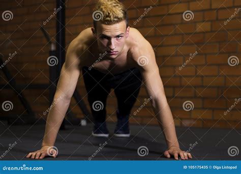 Athlete With A Beautiful Body And A Naked Torso Doing Push Ups Exercise