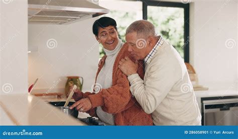 Senior Couple Hug And Cooking At Home With Love Marriage And