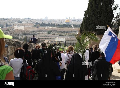 Christian Pilgrims Walk In A Palm Sunday Procession On Mount Olives