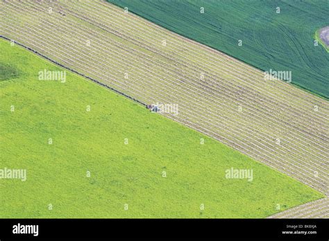 Aerial Of Tractor Harvesting Field Stock Photo - Alamy