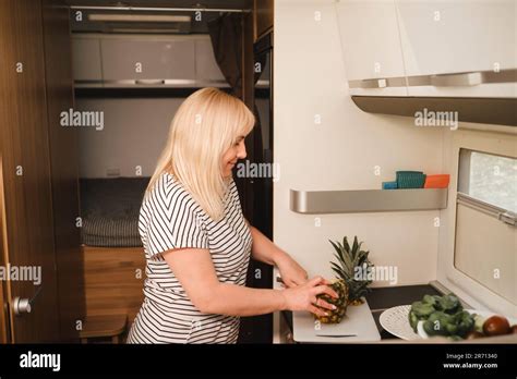 Una Mujer Cocinando Alimentos En La Cocina Dentro De Una Autocaravana