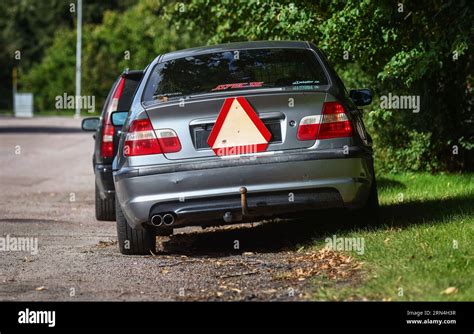 A BMW A Tractor With The Characteristic Warning Triangle For Slow