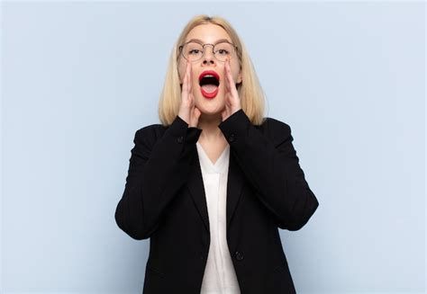 Premium Photo | Blonde woman feeling happy, excited and positive ...