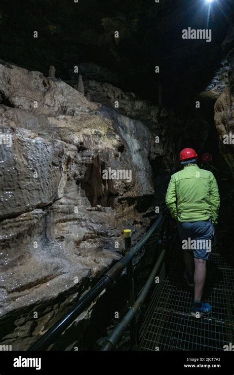 Visitors In Hard Hats Inside The Stunning White Scar Caves In Ingleton