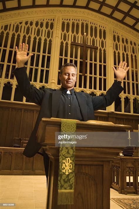 Priest At Podium With Arms Raised High Res Stock Photo Getty Images