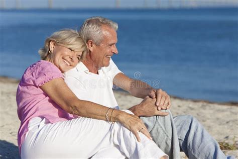 Glückliche ältere Paare Die Zusammen Auf Strand Sitzen Stockbild Bild Von Ruhestand Grau