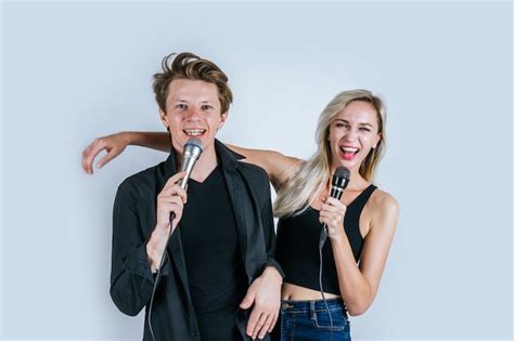 Free Photo Happy Portrait Of Couple Holding Microphone And Sing A Song