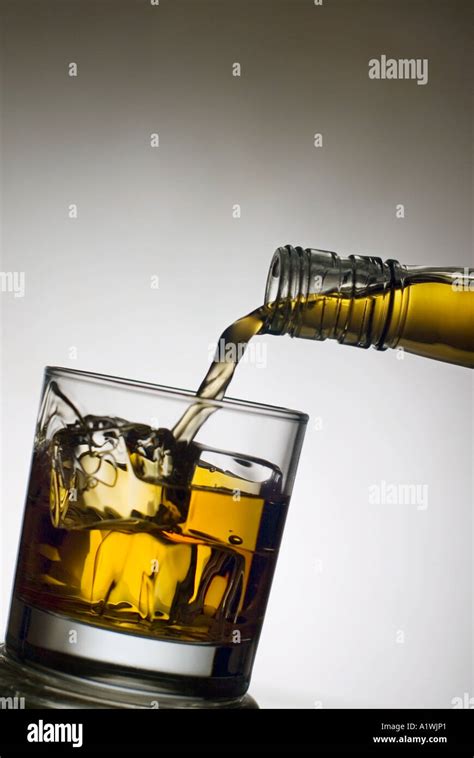 WHISKY POURING INTO GLASS Stock Photo Alamy