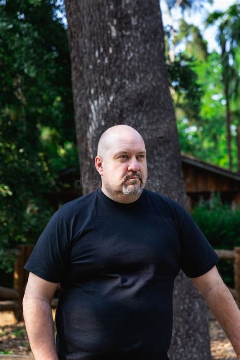 Portrait Of A Bald Mature Man With Goatee Very Serious In A Park Stock