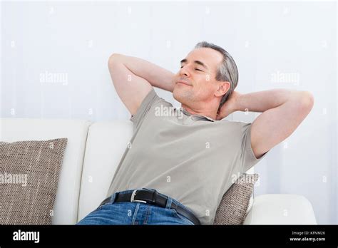 Portrait Of Happy Mature Man Relaxing On Sofa Stock Photo Alamy