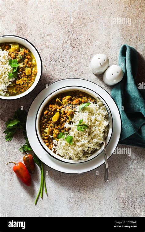 Indian Lentil Dhal With Vegetables And Basmati Rice On The Table