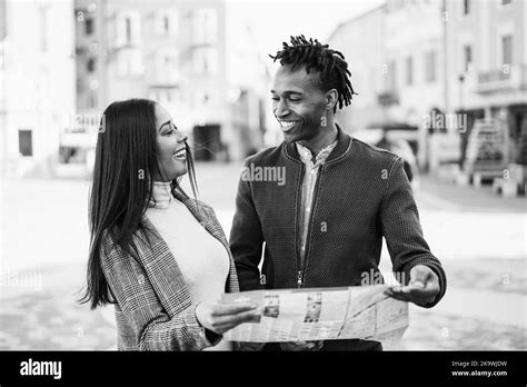 Happy African Couple Having Fun Looking City Map During Travel Vacation