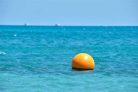 Yellow Buoy Floating On Sea Surface As Marker For Swimming Restriction