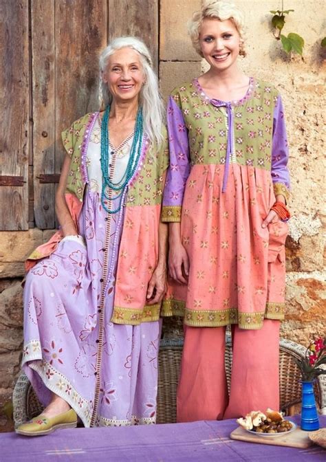 Older Woman With Long White Hair Standing Next To Young Blonde Woman