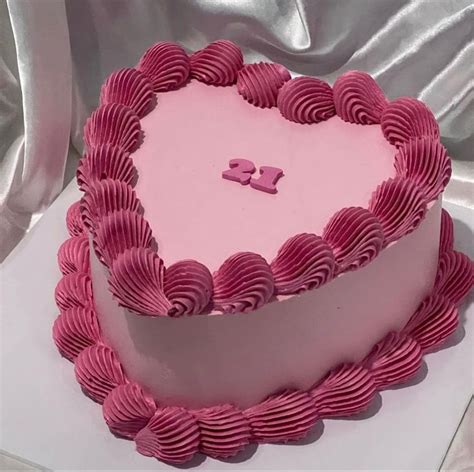 A Heart Shaped Cake With Pink Icing On It