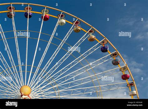 Close Up Of Big Ferris Wheel At Fun Fair Against A Clear Blue Sky Stock