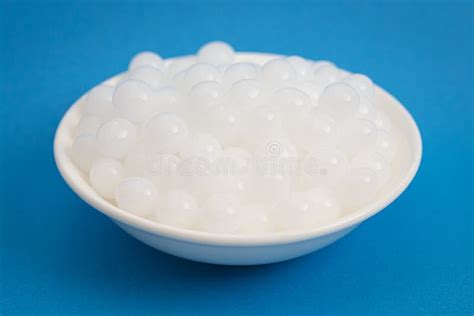 Bowl Of Popping Boba Pearls On A Bright Blue Background Stock Image