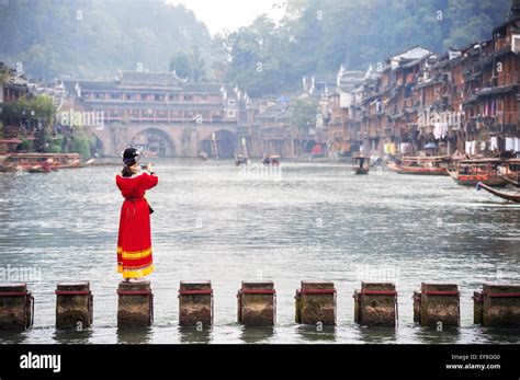 tourist  traditional miao costume takes  picture   tuojiang