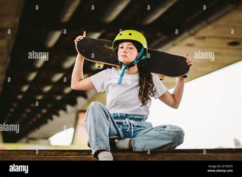 Close Up Of Young Attractive Girl With Skateboard Standing Outdoors In