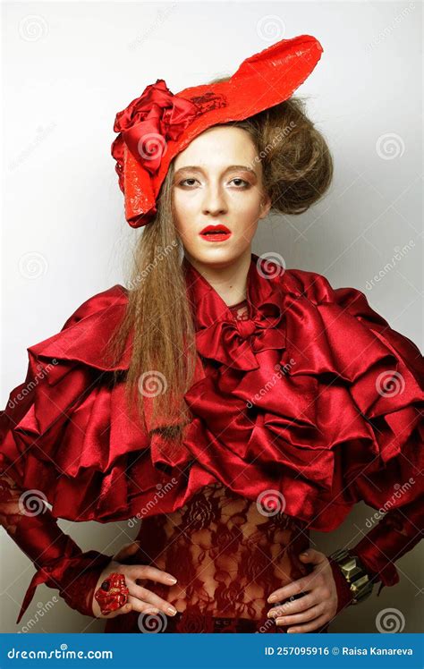 Young Beautiful Woman In A Red Lace Suit And Hat A Stylish Blonde In