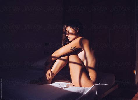 Naked Woman With Shadows by Stocksy Contributor Susana Ramírez Stocksy