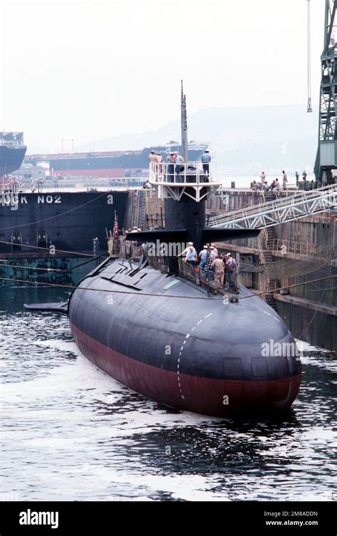 Crew Members Stand At The Railing Of The Attack Submarine Uss Barbel