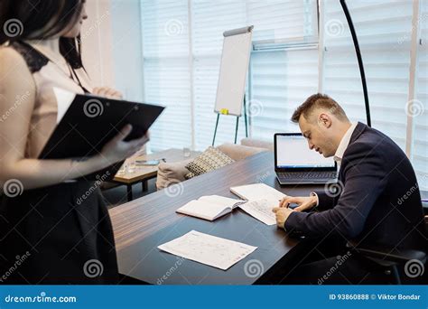 Businessman And His Assistant Secretary In His Office The Secretary Brought The Boss Documents