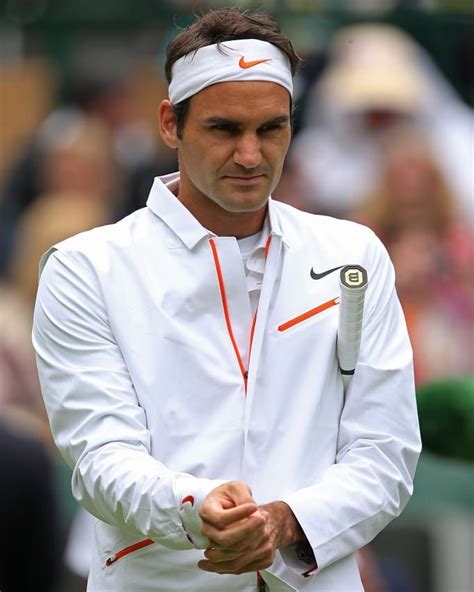 Roger Federer Dressed In Pristine White Hitting A Backhand Pass On