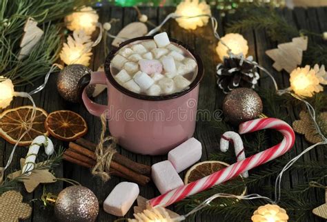Pink Cup Of Hot Chocolate With Marshmallows On A Wooden Background Surrounded By Christmas Toys