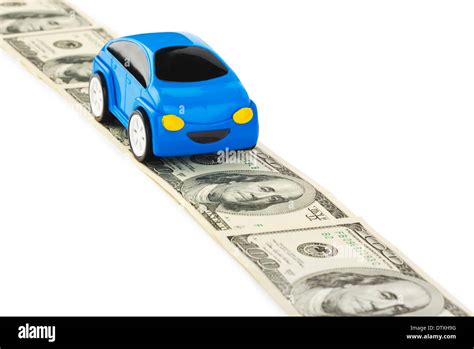 Toy car on money road Stock Photo - Alamy
