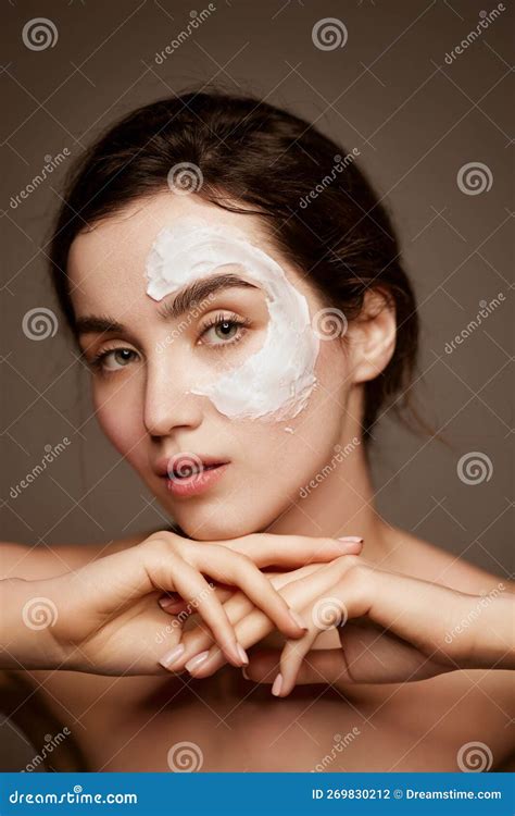 Cosmetics Face Care Portrait Of Young Brunette Beautiful Girl With Face Mask On Well Kept Skin