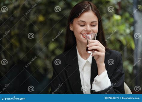 Woman With Red Lips Smile With Teeth Drinks Tea In A Cafe From A