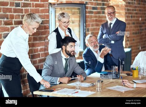 Bearded Caucasian Brunette Man In Gray Suit Offers Idea Near Blonde Assistant Other Listen