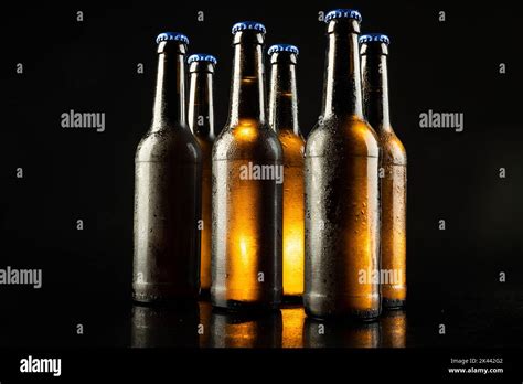 Image Of Six Beer Bottles With Blue Crown Caps With Copy Space On