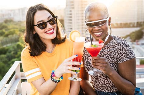 Stylish Multiethnic Lesbian Females Drinking Cold Refreshing Cocktails