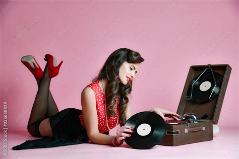 Glamorous Pinup Girl Lying Near Retro Gramophone Holding Lp Vinyl