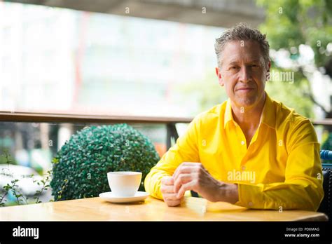 Portrait Of Mature Handsome Man Sitting In Coffee Shop Stock Photo Alamy