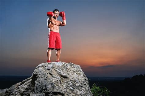 Premium Photo Muscular Male Boxer Looking At Camera Outdoors