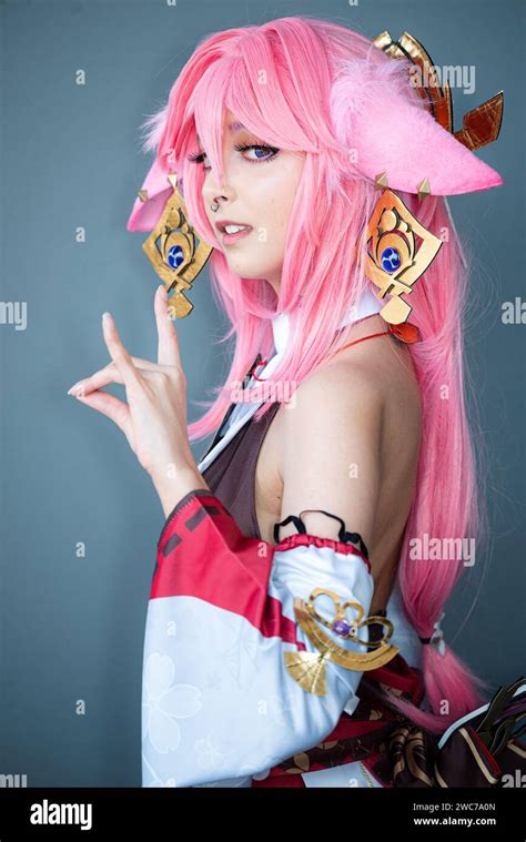 A Female cosplayer in a pink anime costume wearing pink hair Stock Photo - Alamy