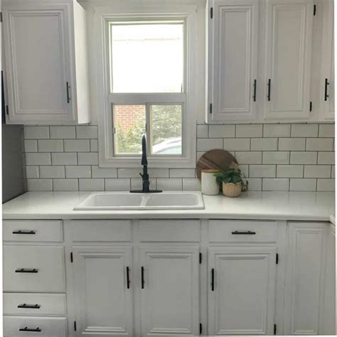 All White Minimalist Kitchen With Subway Tile Backsplash Soul And Lane