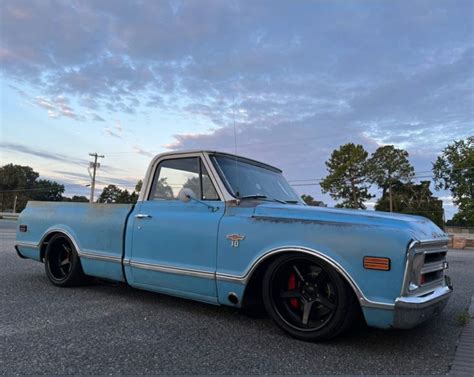 An Old Blue Truck Parked In A Parking Lot