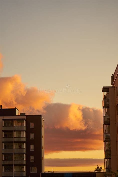 Colorful Clouds Behind A Multi Storey Building At Sunset Stock Image